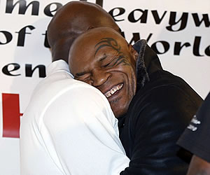 Mike Tyson hugs Evander Holyfield
